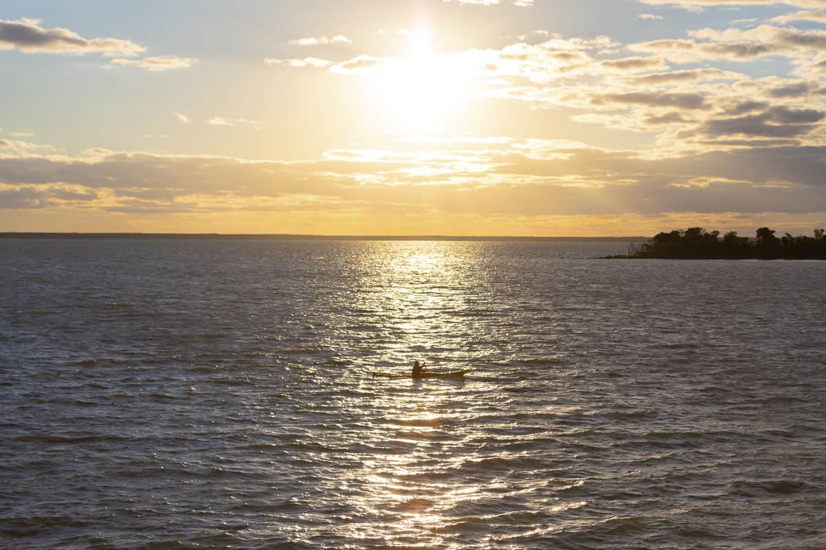 A boater in Lake Manitoba during sunset