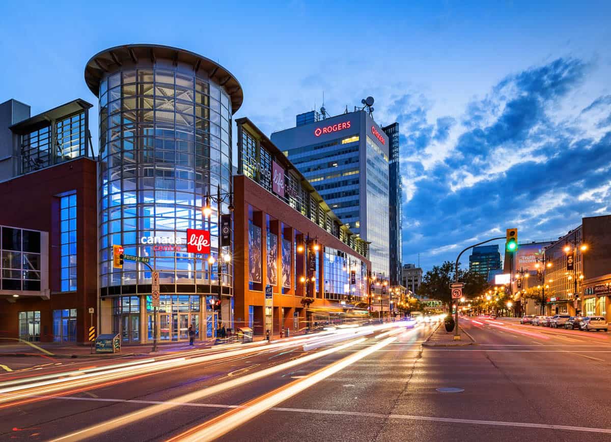 Traffic in front of the Canada Life Centre at dusk.